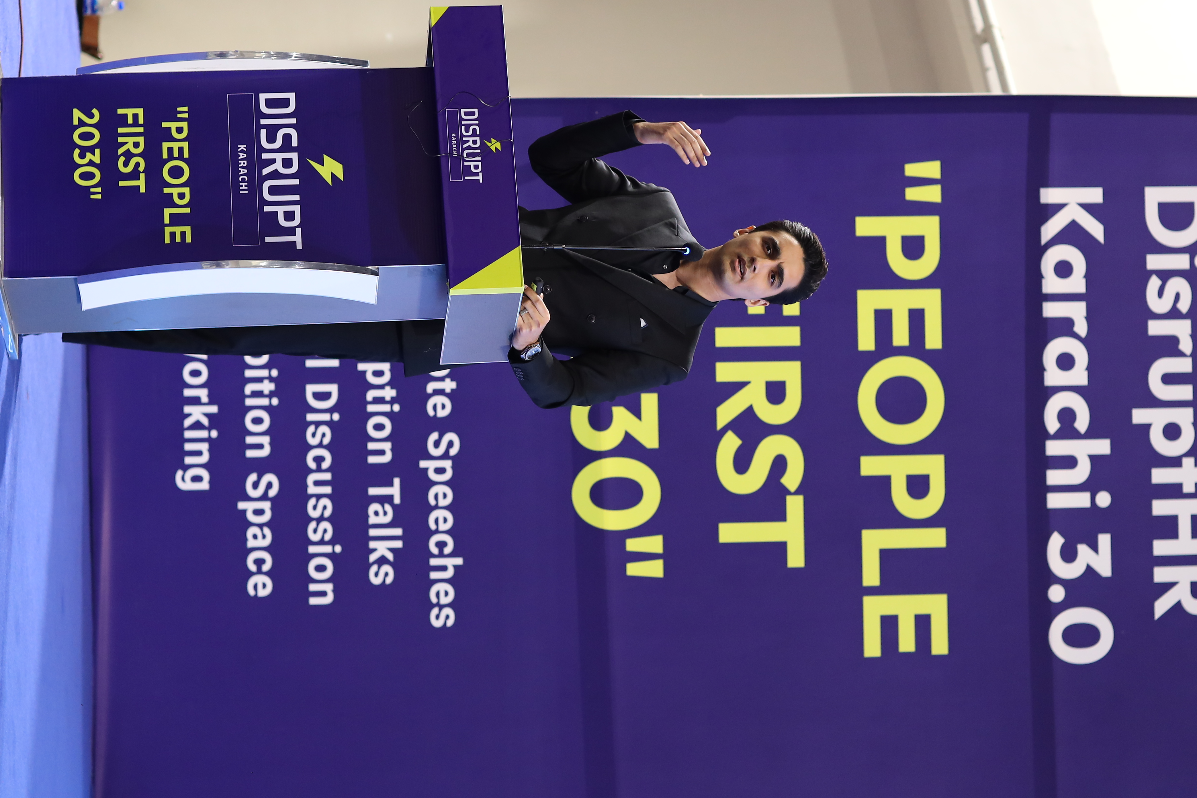 Businessman giving presentation on stage with 