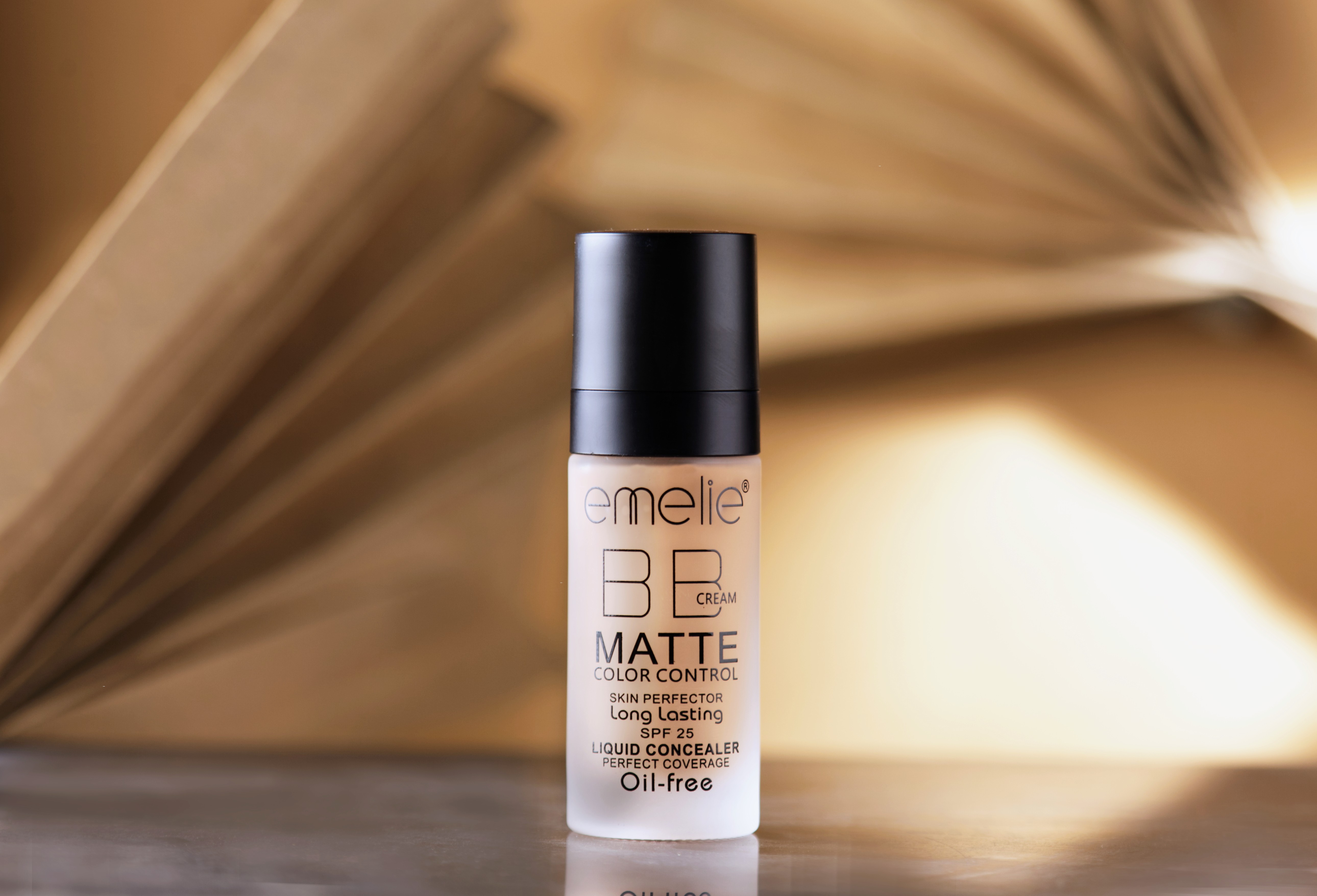 Liquid foundation bottle with black cap on soft background