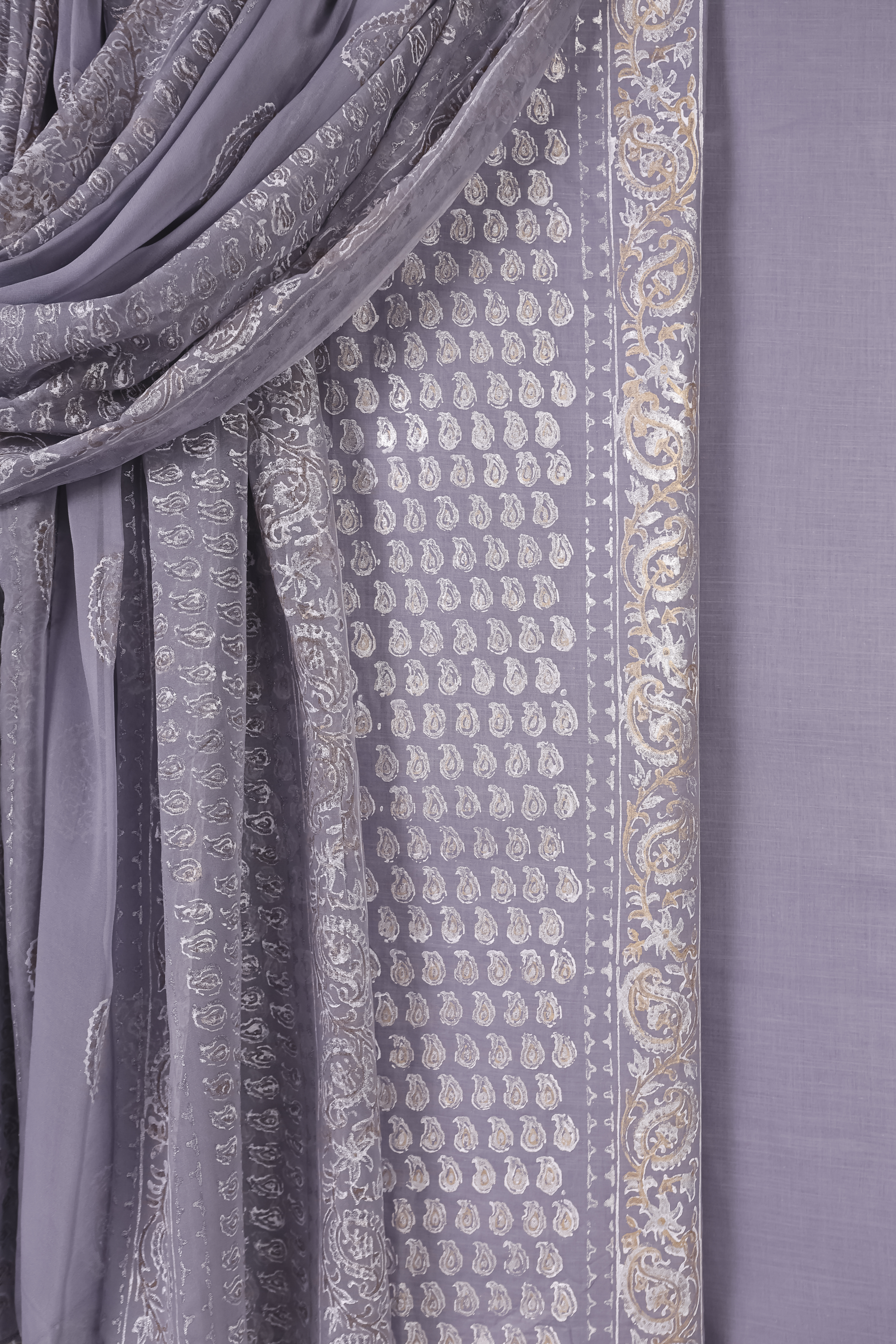 Decorative fabric with intricate traditional patterns in soft tones