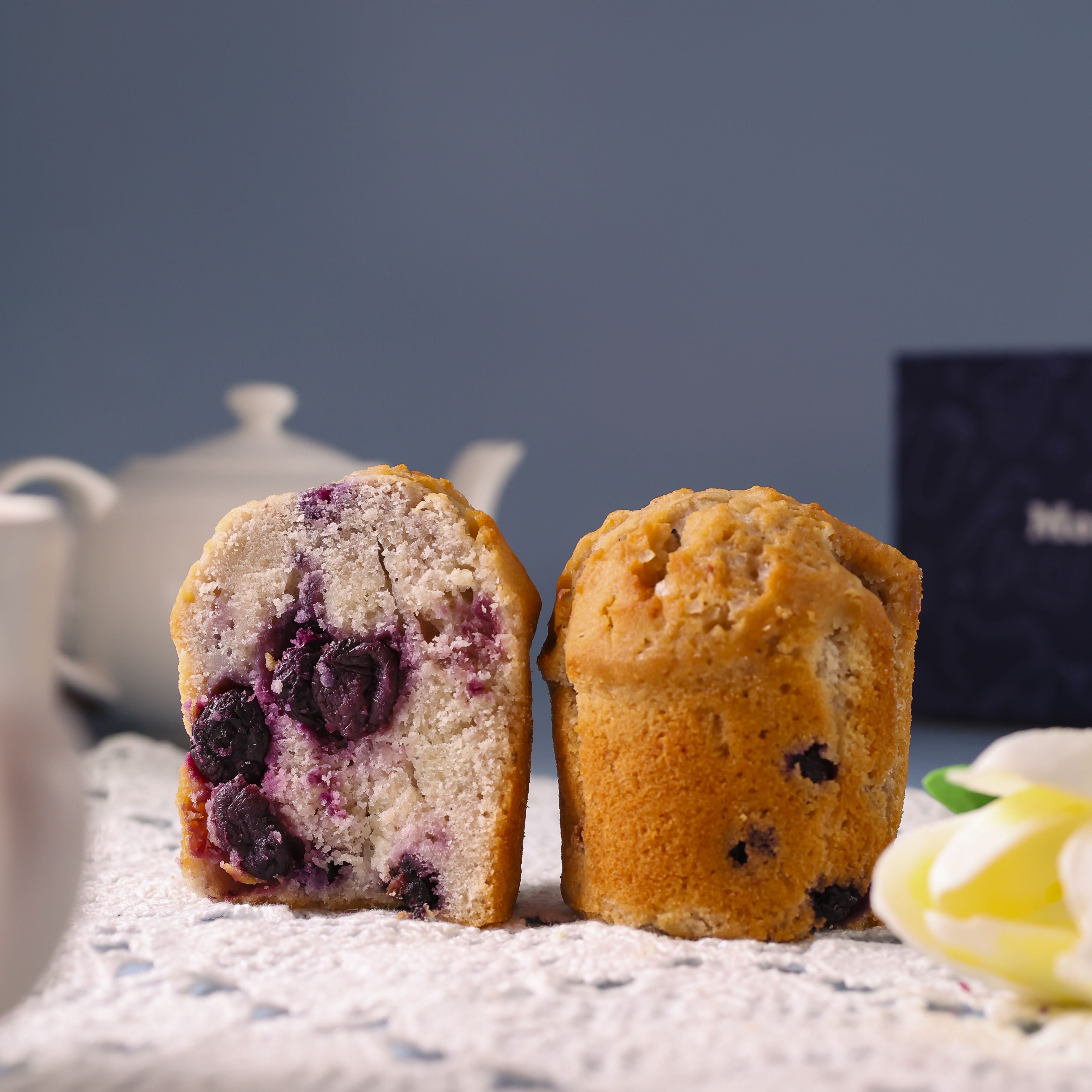 Fresh  blueberry and vanilla muffins on a table with soft background lighting