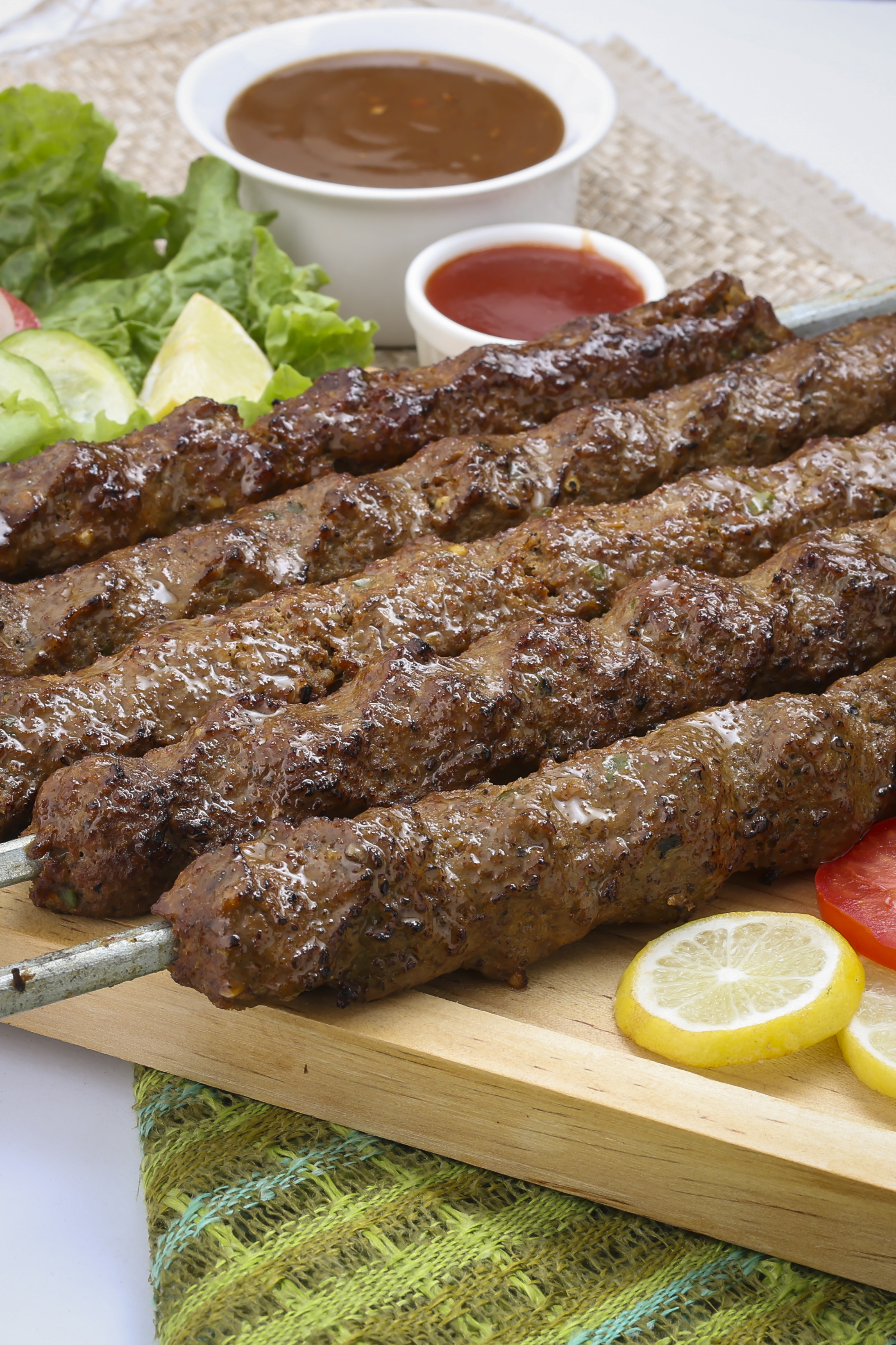 Juicy grilled seekh kebabs served with chutney and fresh salad