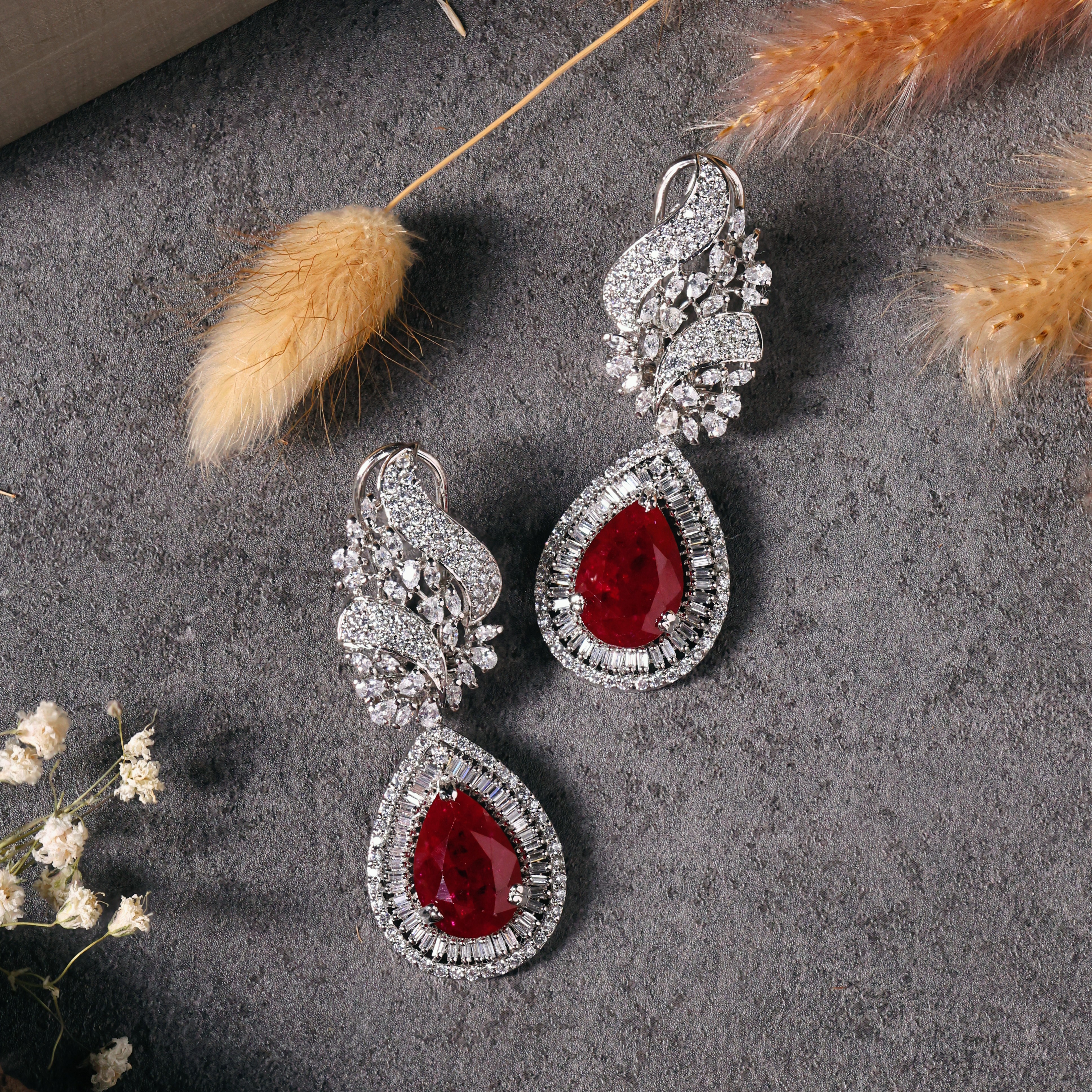 Luxury jewelry set with diamond detailing and red gemstone centerpiece